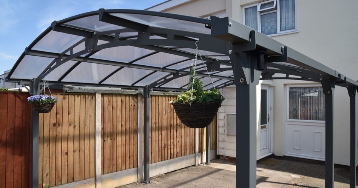 Aluminium carport with a curved polycarbonate roof installed by Hampshire Verandas